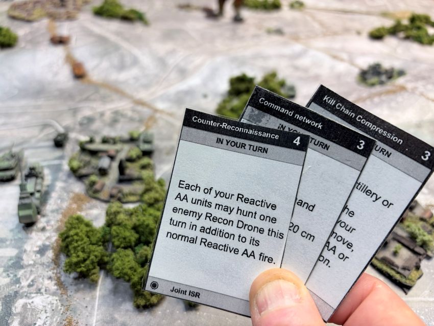 A hand fanning Counter-Reconnaissance, Command network and Kill Chain Compression cards