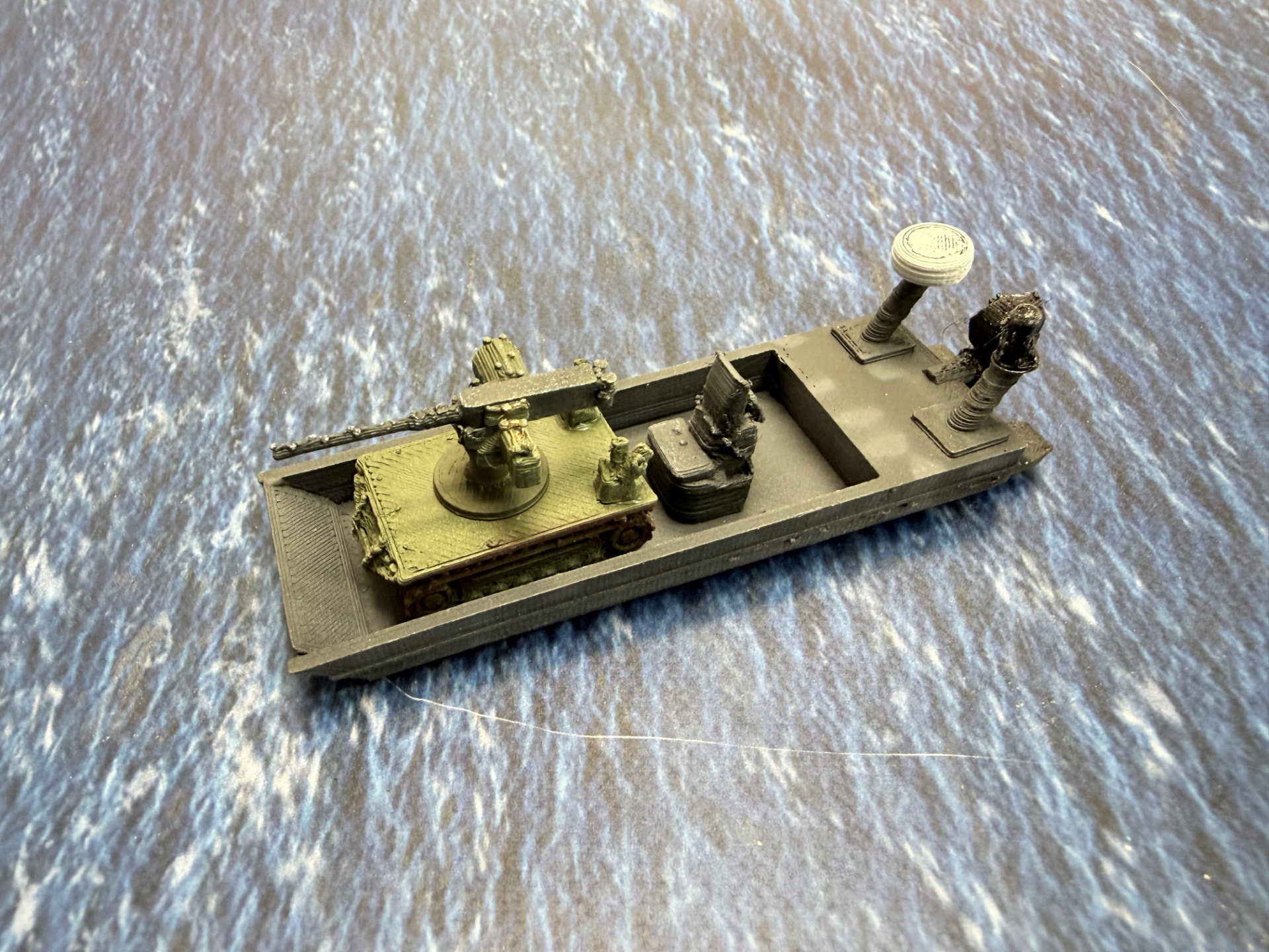 A painted USV beside a UGV on a sea mat