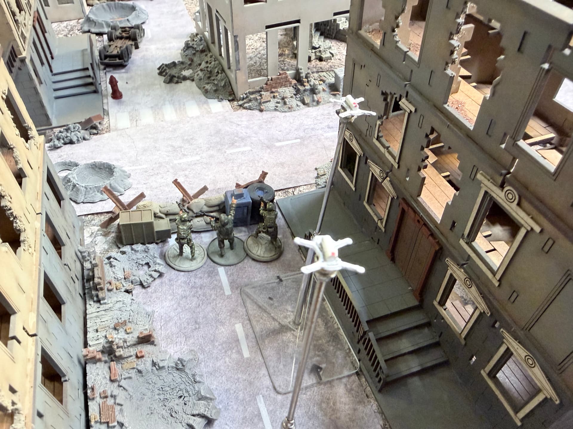 Drones flying through a ruined street on the Skirmish table