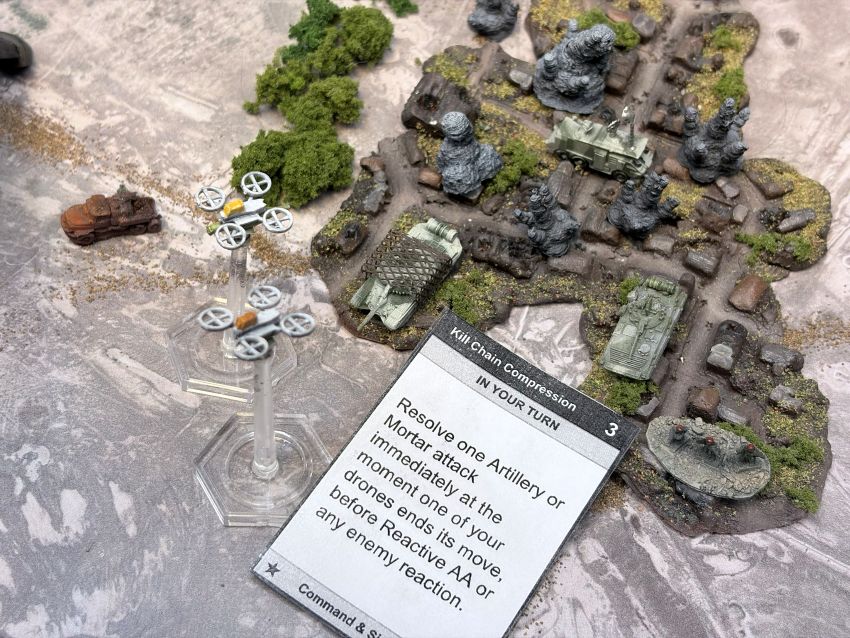 Kill Chain Combat Enabler card with an explosion landing on a vehicle on the 6 mm table